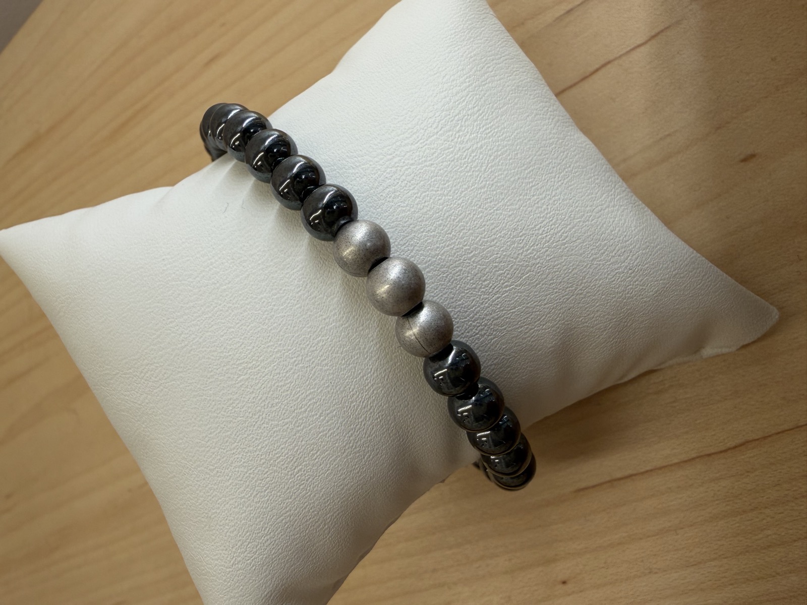 Hematite men's bracelet on a pillow