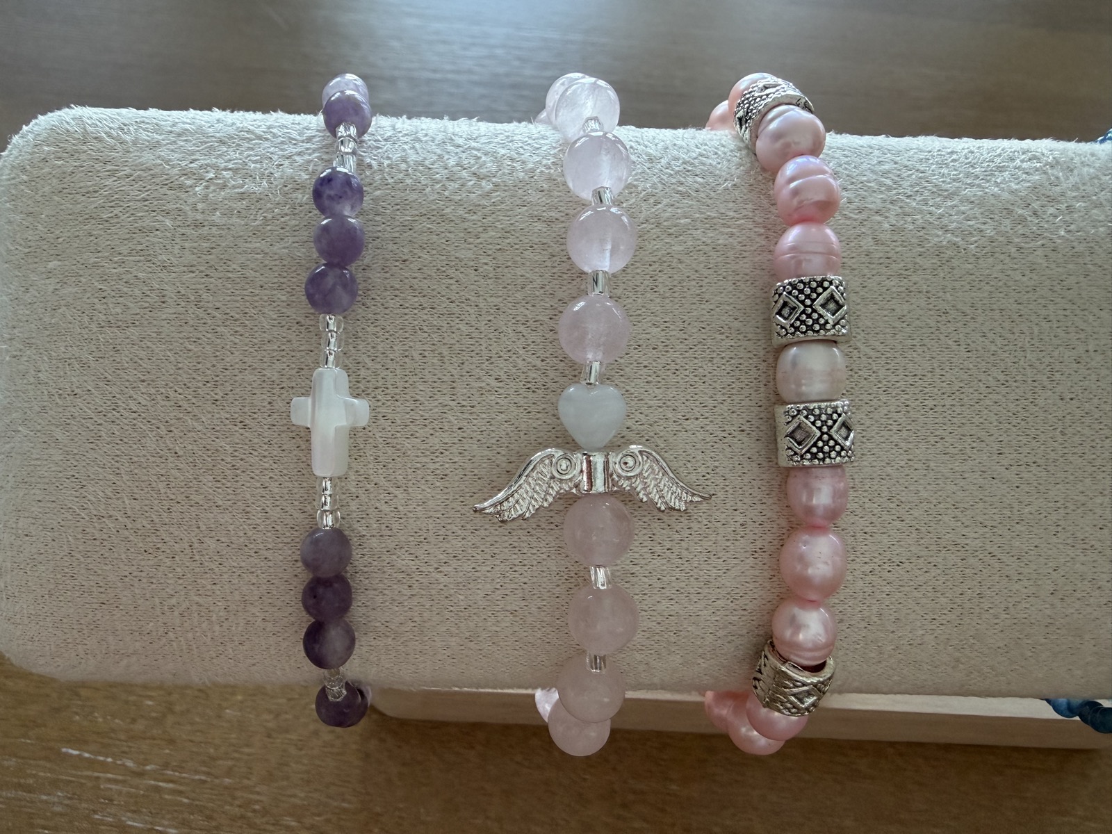 Cross, angel wing and pearl bracelets