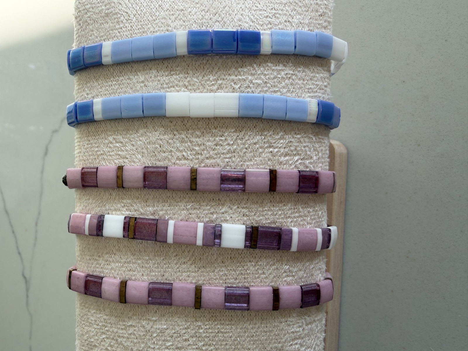 Blue and pink tile bracelets on display