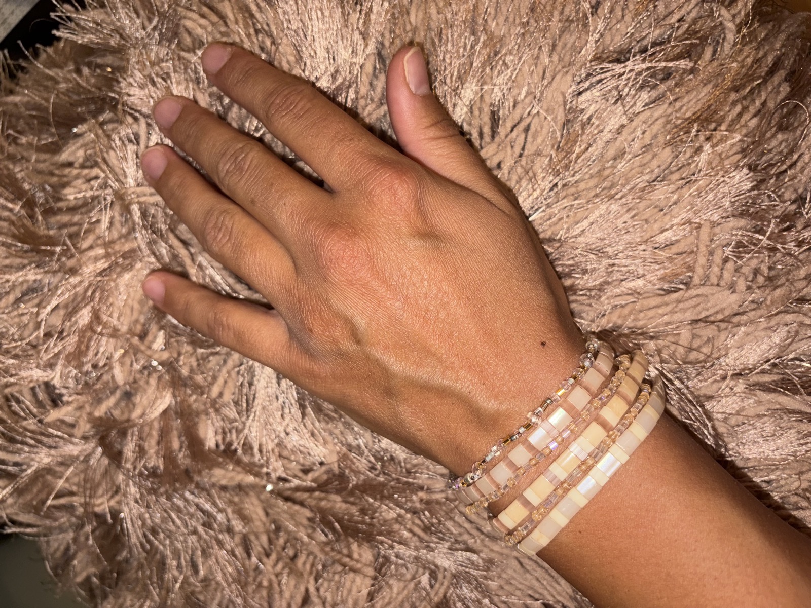Women's tile bracelets stacked on a wrist